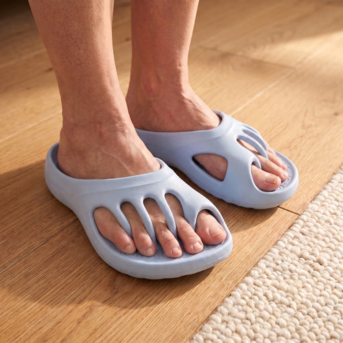 Roomtoes slides on a wooden floor