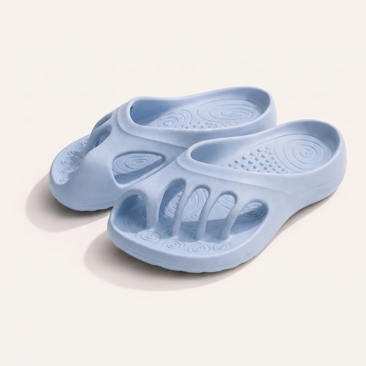 A pair of baby blue RoomToes slides